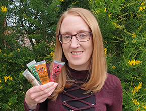 Staff member holds up hand cream for NHS staff